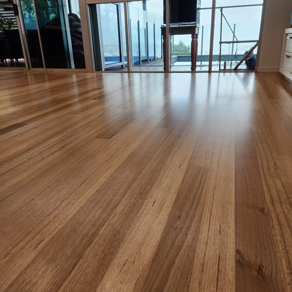 A Wooden Floor in a Room With a Lot of Windows — ATM Floors In Mount Louisa, QLD