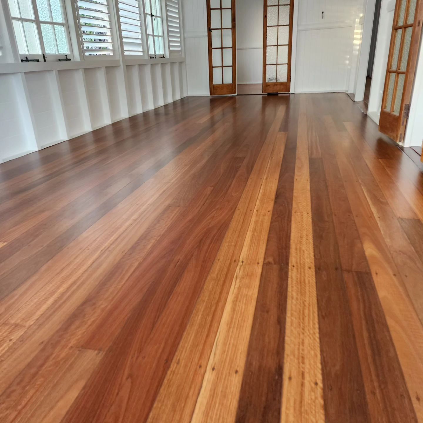 A Large Building With a Wooden Floor and Stairs — ATM Floors In Mount Louisa, QLD