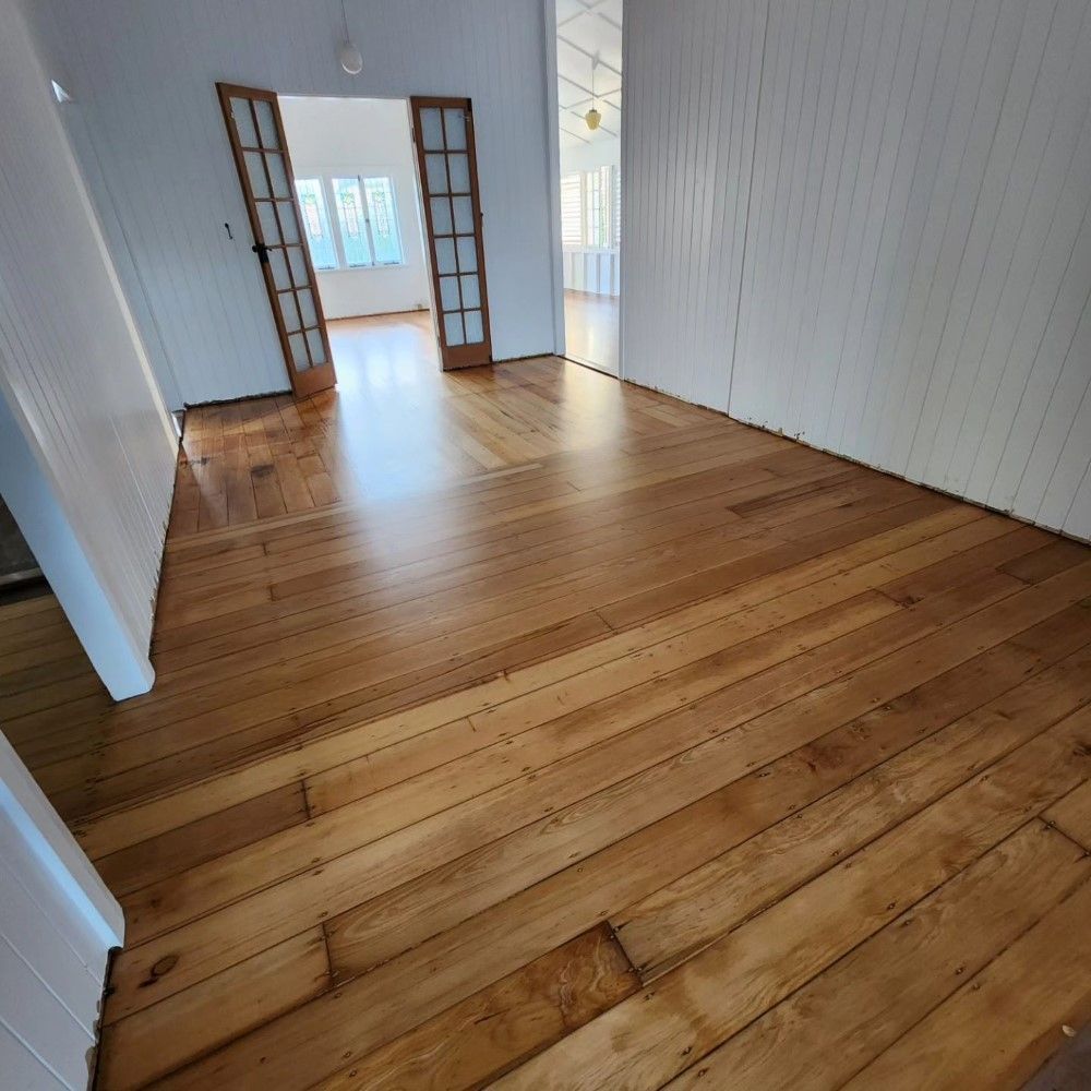 A Room With Wooden Floors and White Walls — ATM Floors In Mount Louisa, QLD
