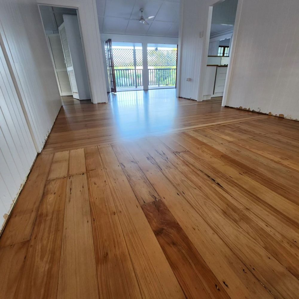 A Room With a Wooden Floor and White Walls — ATM Floors In Mount Louisa, QLD