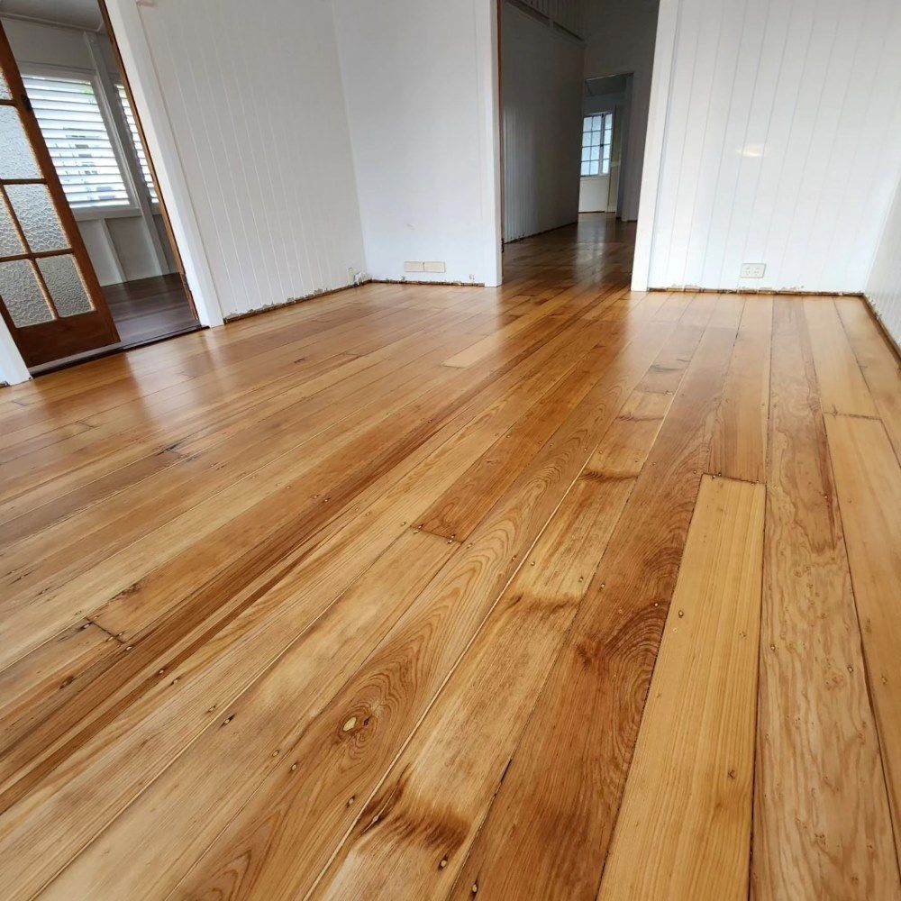 A Room With a Wooden Floor and White Walls — ATM Floors In Mount Louisa, QLD