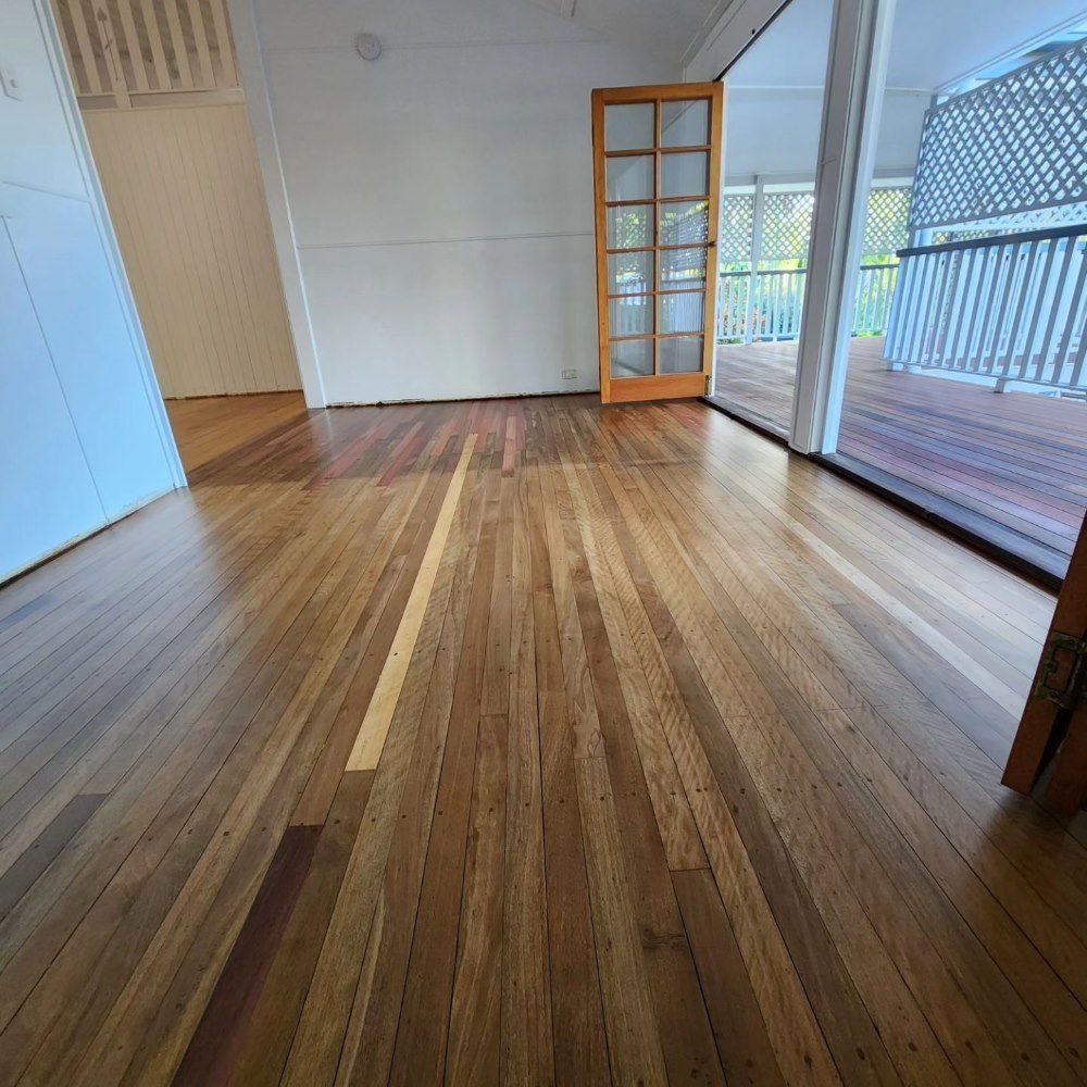 A Room With a Wooden Floor and a Door Leading to a Porch — ATM Floors In Mount Louisa, QLD