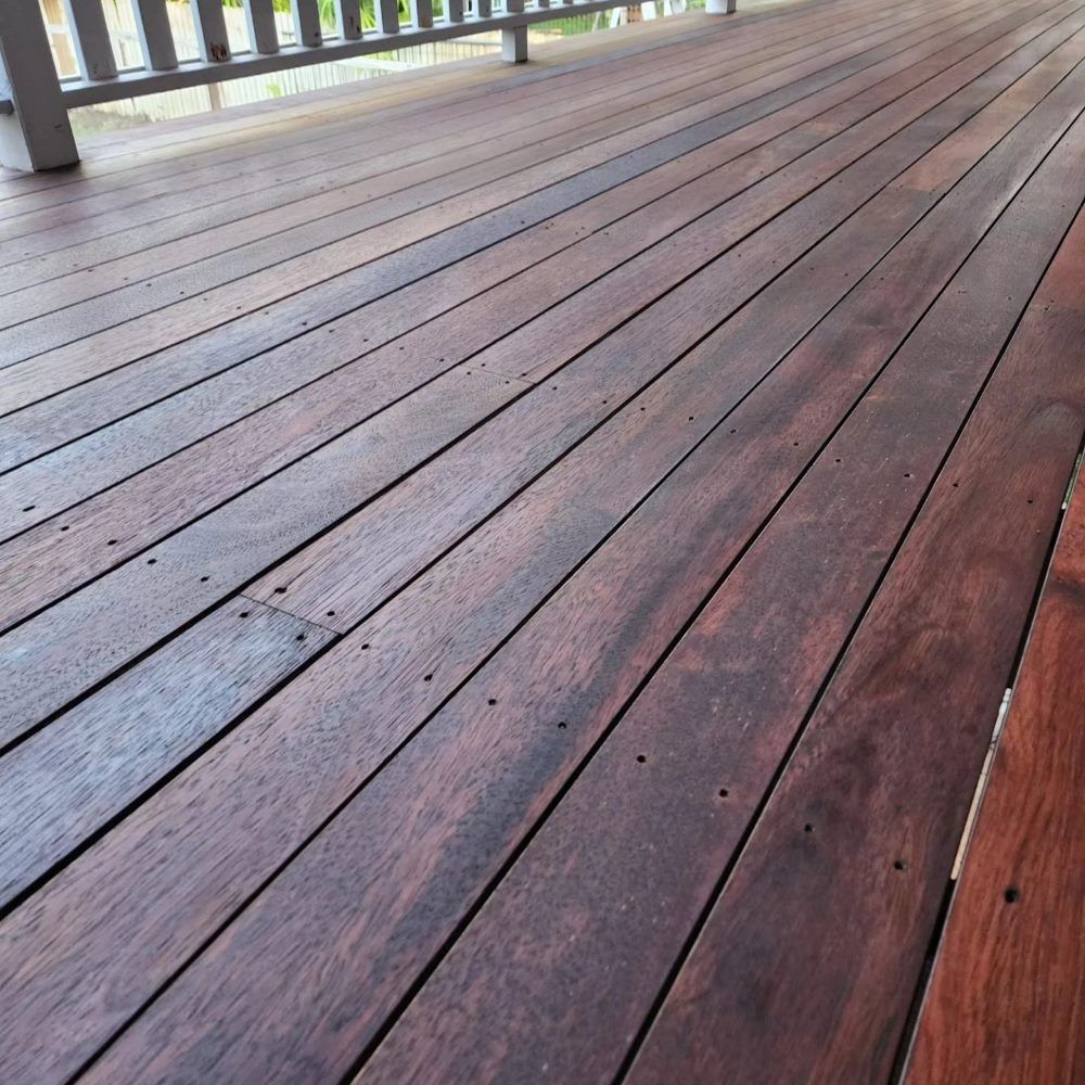 A Wooden Deck With a Railing in the Background — ATM Floors In Mount Louisa, QLD