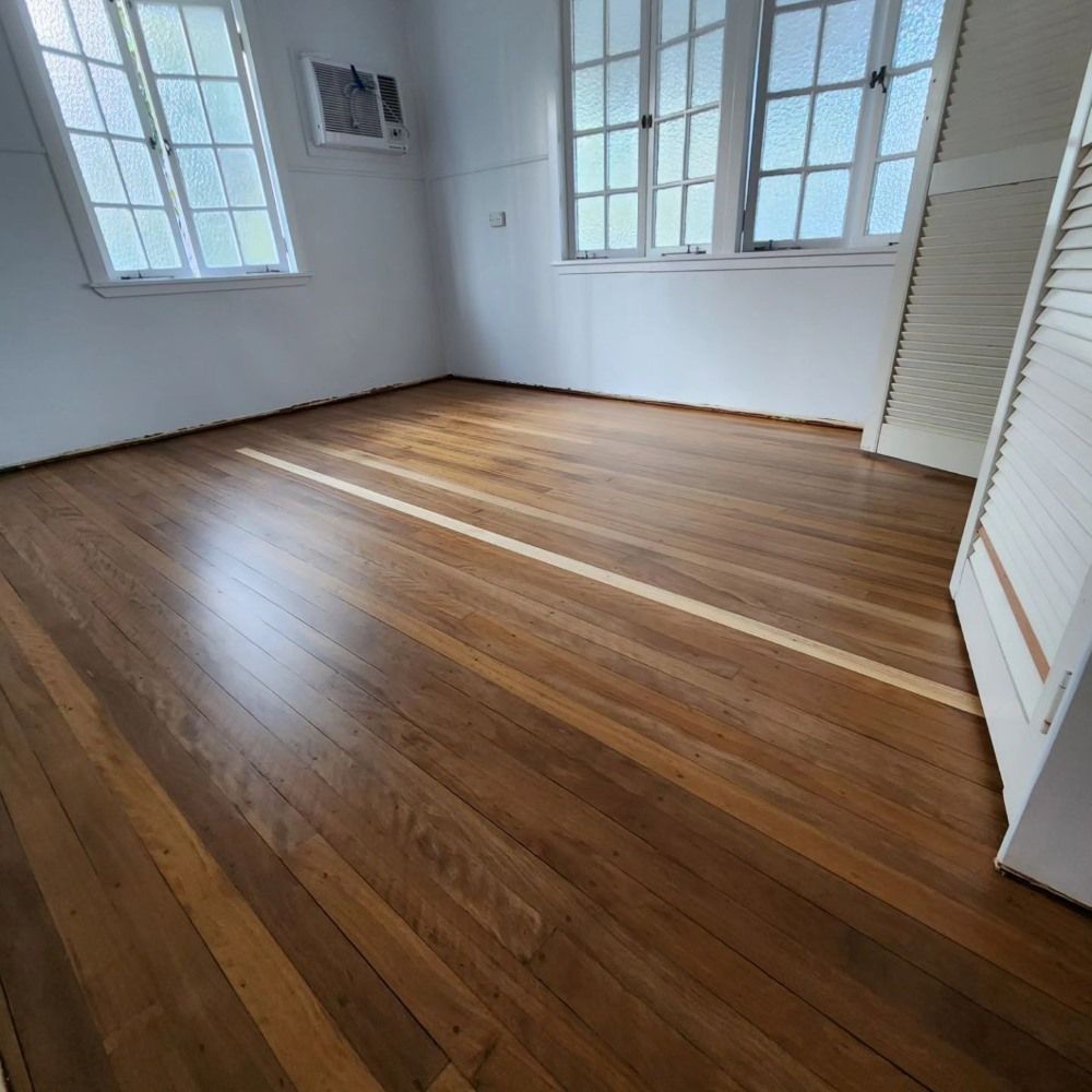 A Room With Hardwood Floors and White Walls — ATM Floors In Mount Louisa, QLD