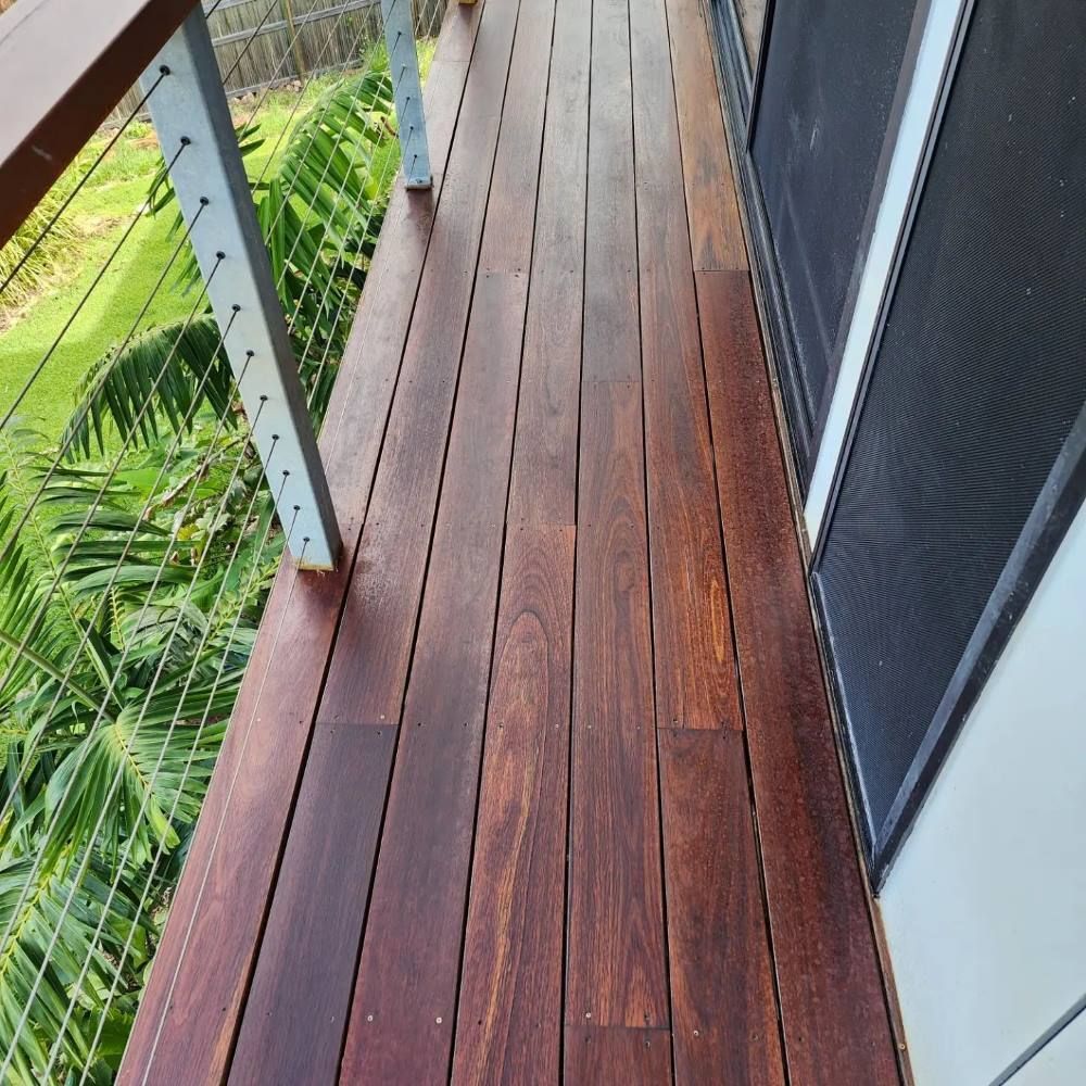 A Room With A Wooden Floor And A Sliding Glass Door — ATM Floors In Ayr, QLD A Wooden Deck With a Wire Railing and a Screen Door — ATM Floors In Ayr, QLD