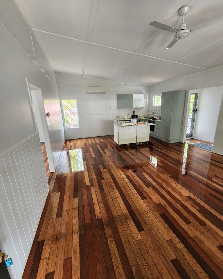 A Large Room With a Wooden Floor and a Lot of Windows — ATM Floors In Mount Louisa, QLD