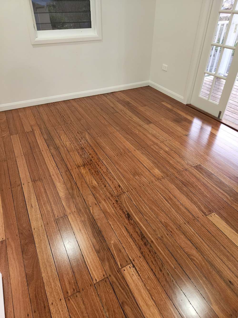 A Room With a Wooden Floor and a Window — ATM Floors In Ingham, QLD