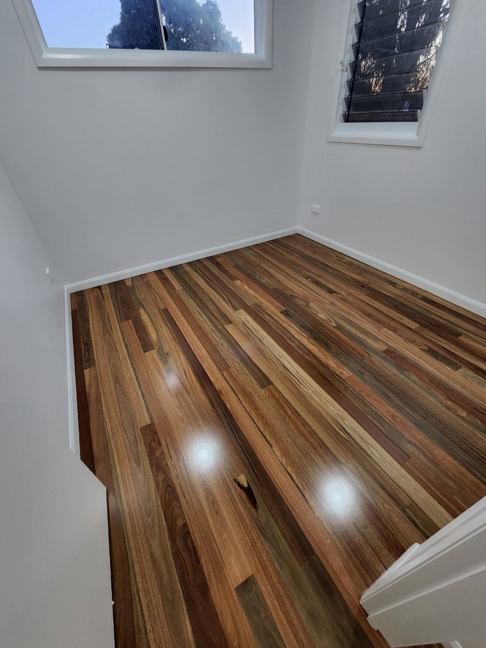 A Room With a Wooden Floor and a Window — ATM Floors In Ayr, QLD