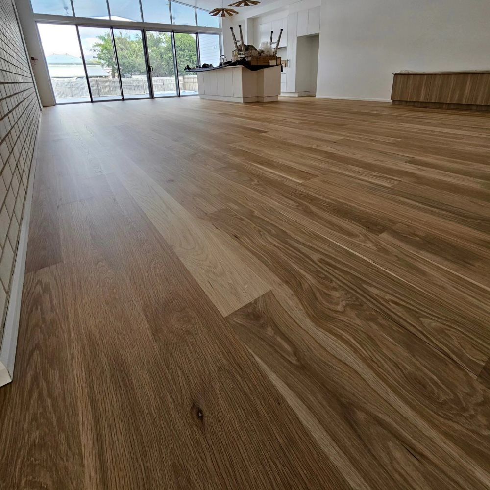 A Large Room With a Wooden Floor and a Lot of Windows — ATM Floors In Mount Louisa, QLD