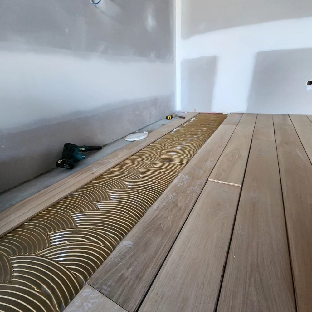 A Wooden Floor is Being Installed in a Room — ATM Floors In Mount Louisa, QLD