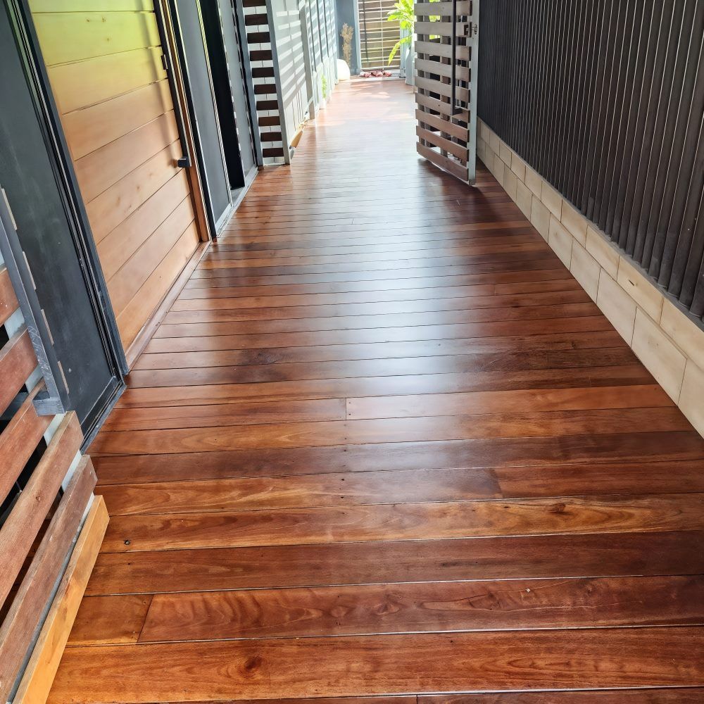 A Room With A Wooden Floor And Sliding Glass Doors — ATM Floors In Townsville, QLD