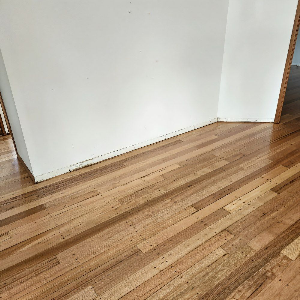 A Close Up Of A Wooden Floor With A Striped Pattern — ATM Floors In Mount Louisa, QLD