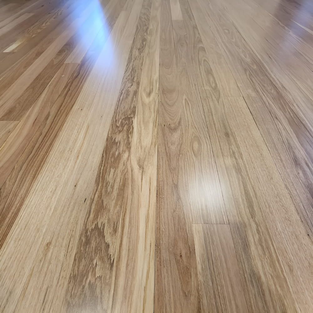 A Close Up of a Wooden Floor With a Shiny Finish — ATM Floors In Mount Louisa, QLD