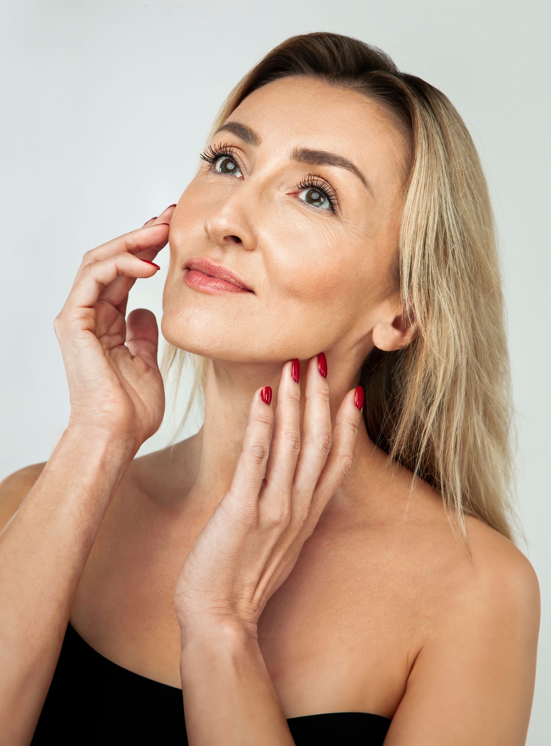 a woman is holding her face