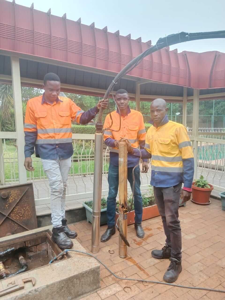 A group of men are standing next to each other in front of a building.