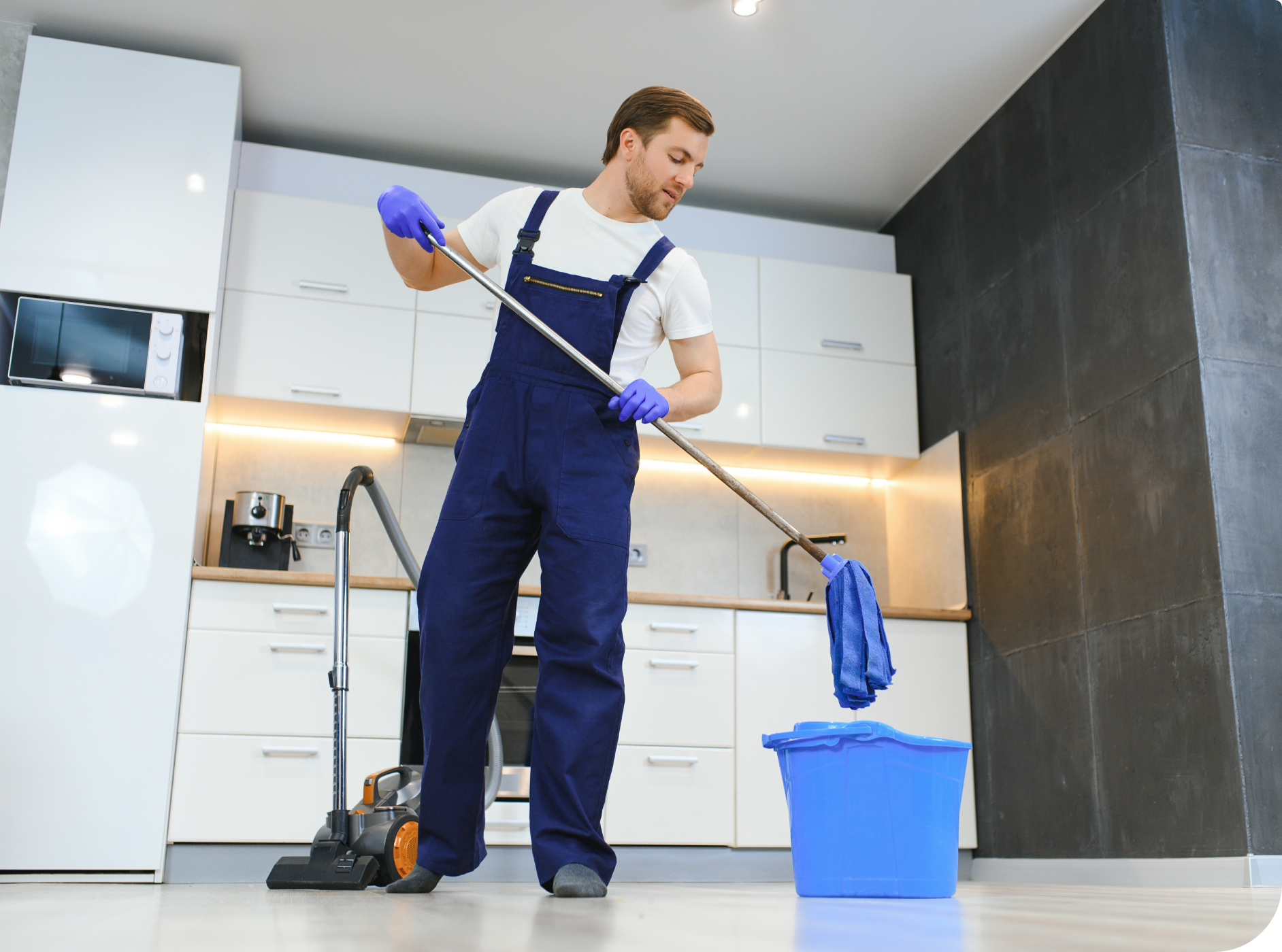 Man mopping a kitchen floor.