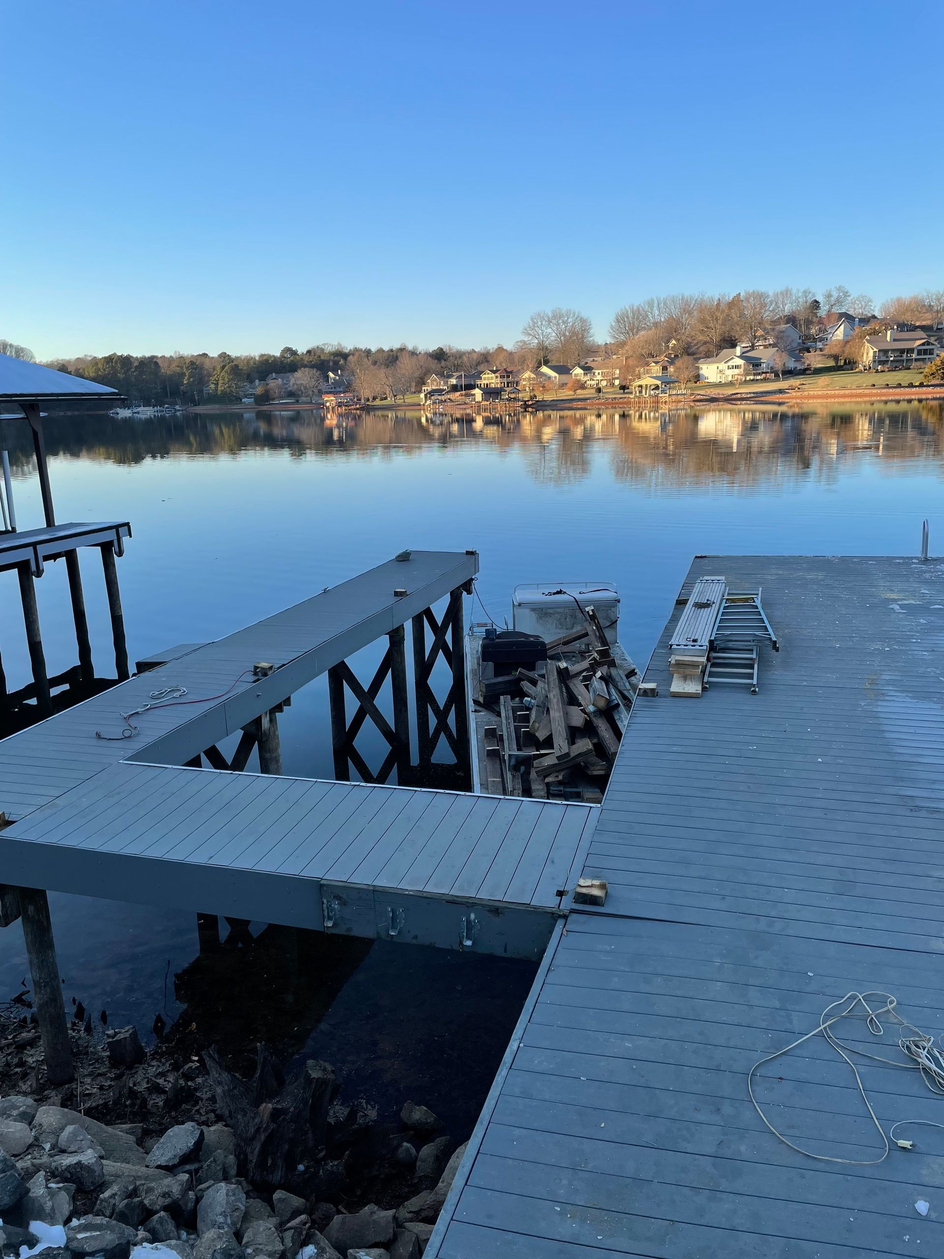 A dock overlooking a body of water with a blue sky in the background