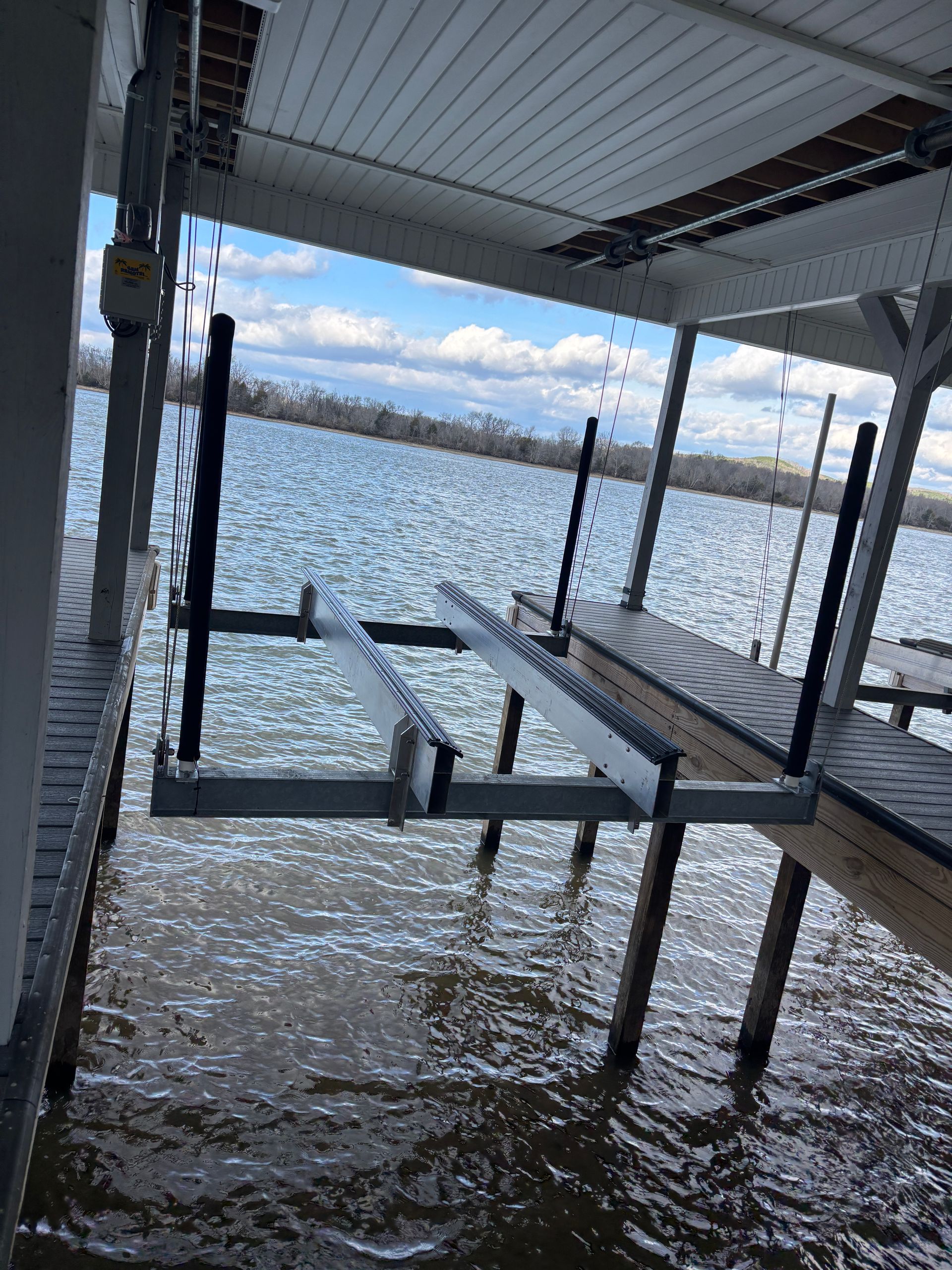 A boat lift is sitting in the middle of a lake.