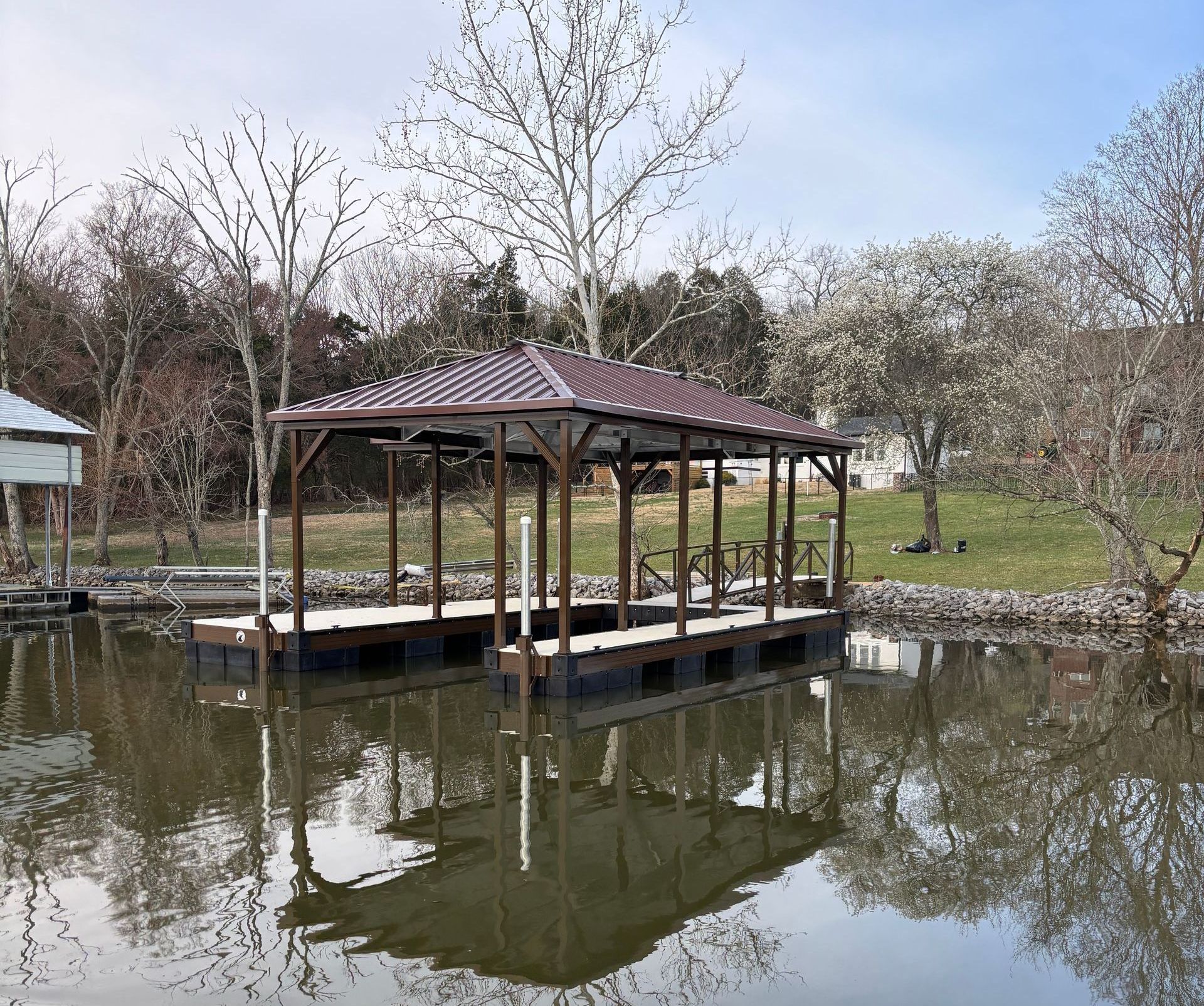A dock in the middle of a lake with trees in the background