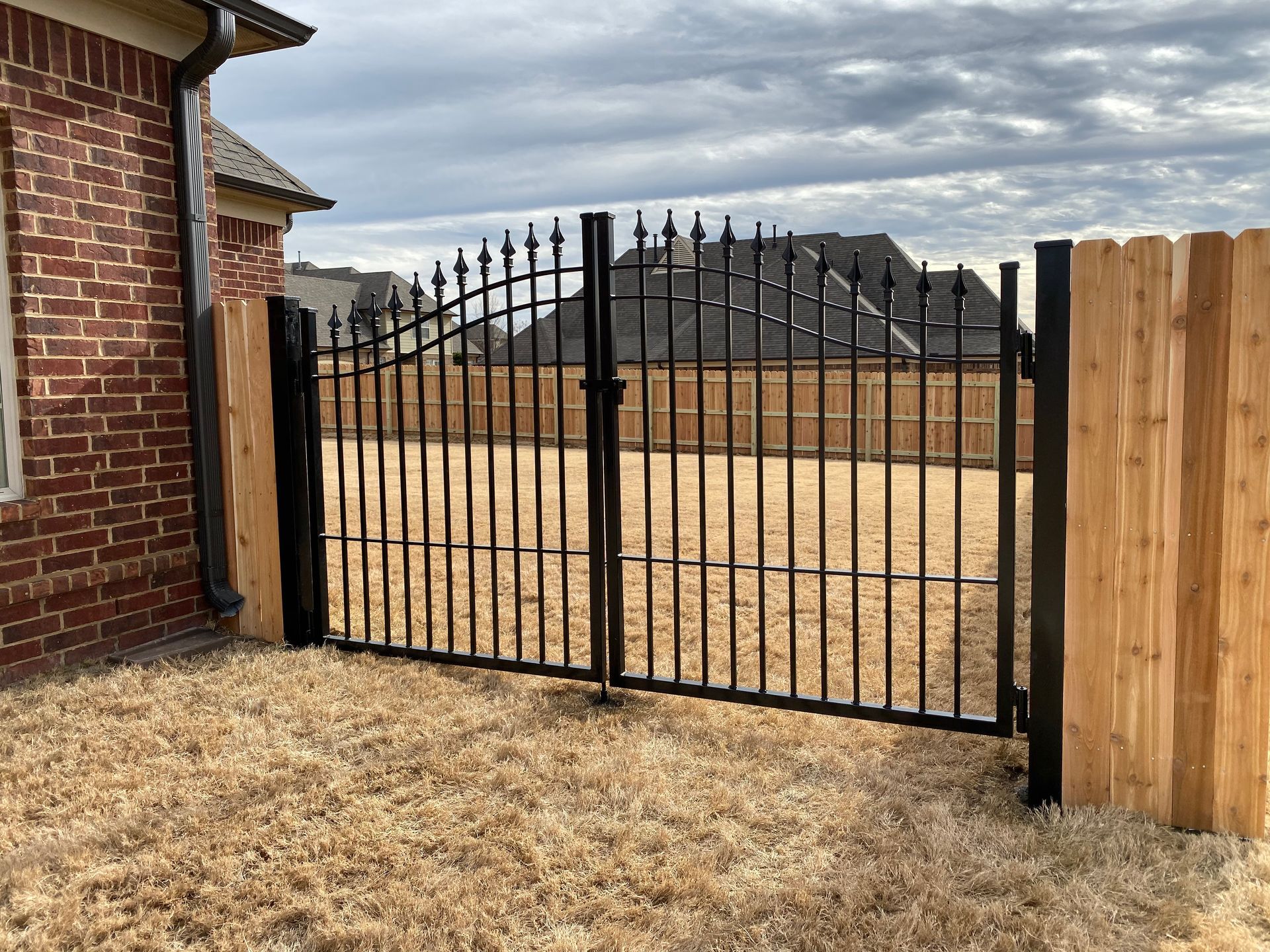 Iron Gate with bell arch added to wood fence