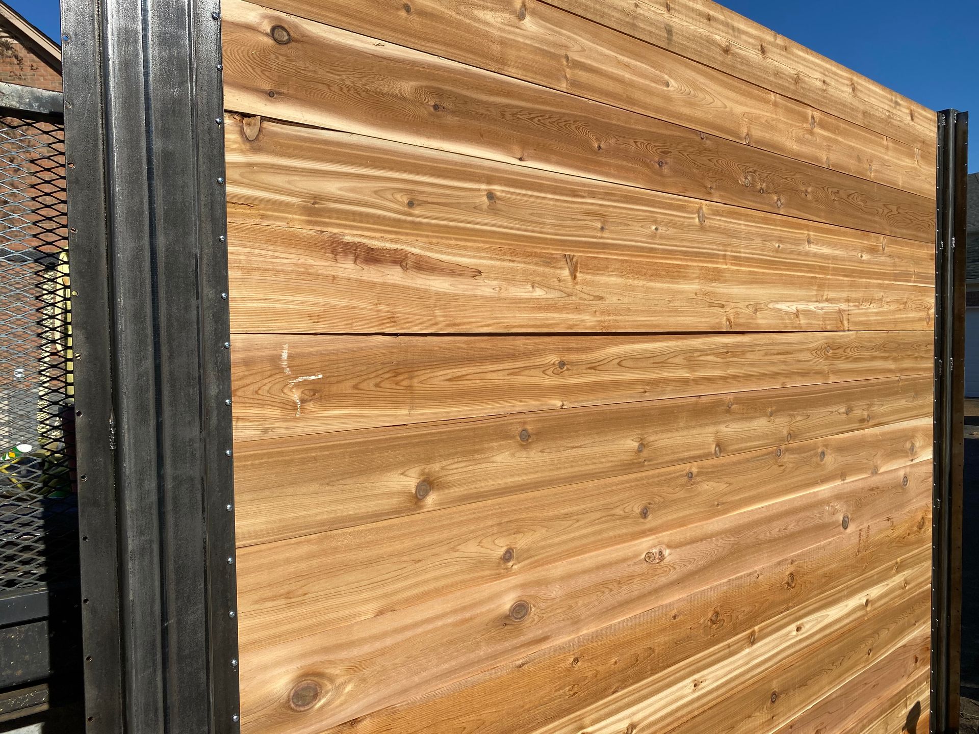 Cedar horizontal fence with steel post and steel cleats