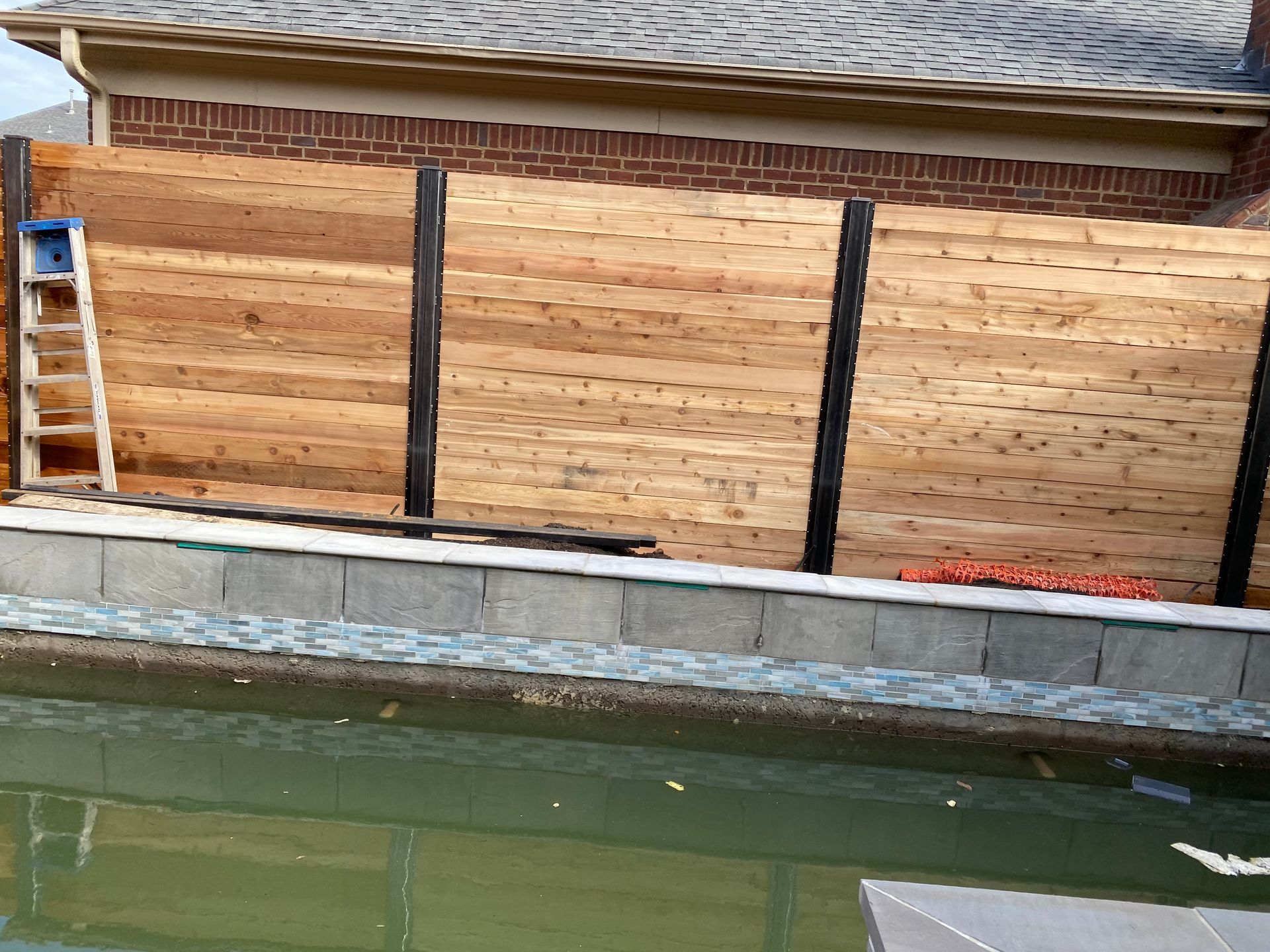 Cedar horizontal fence with steel post and steel cleats