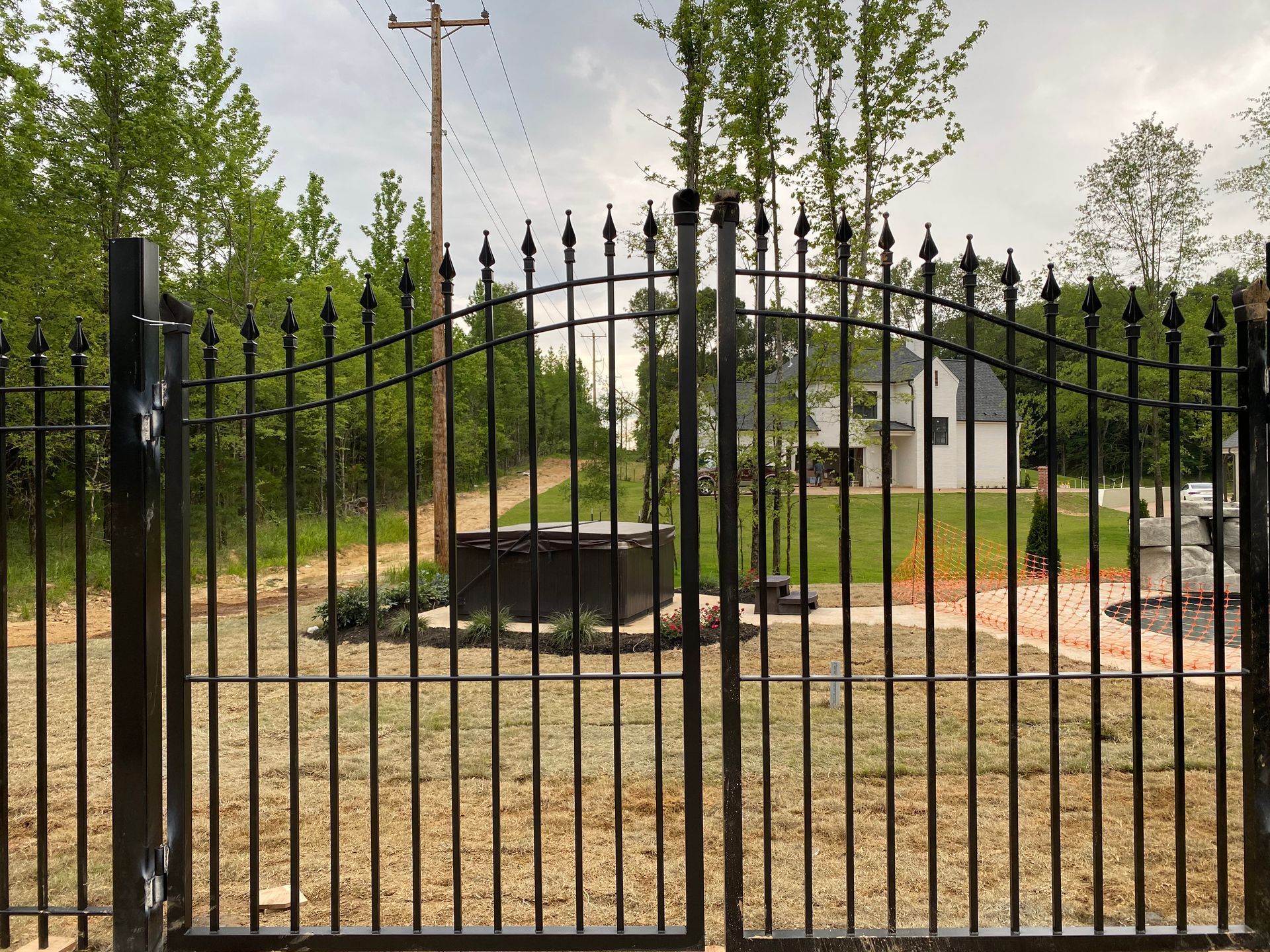 Iron fence with bell arch gate
