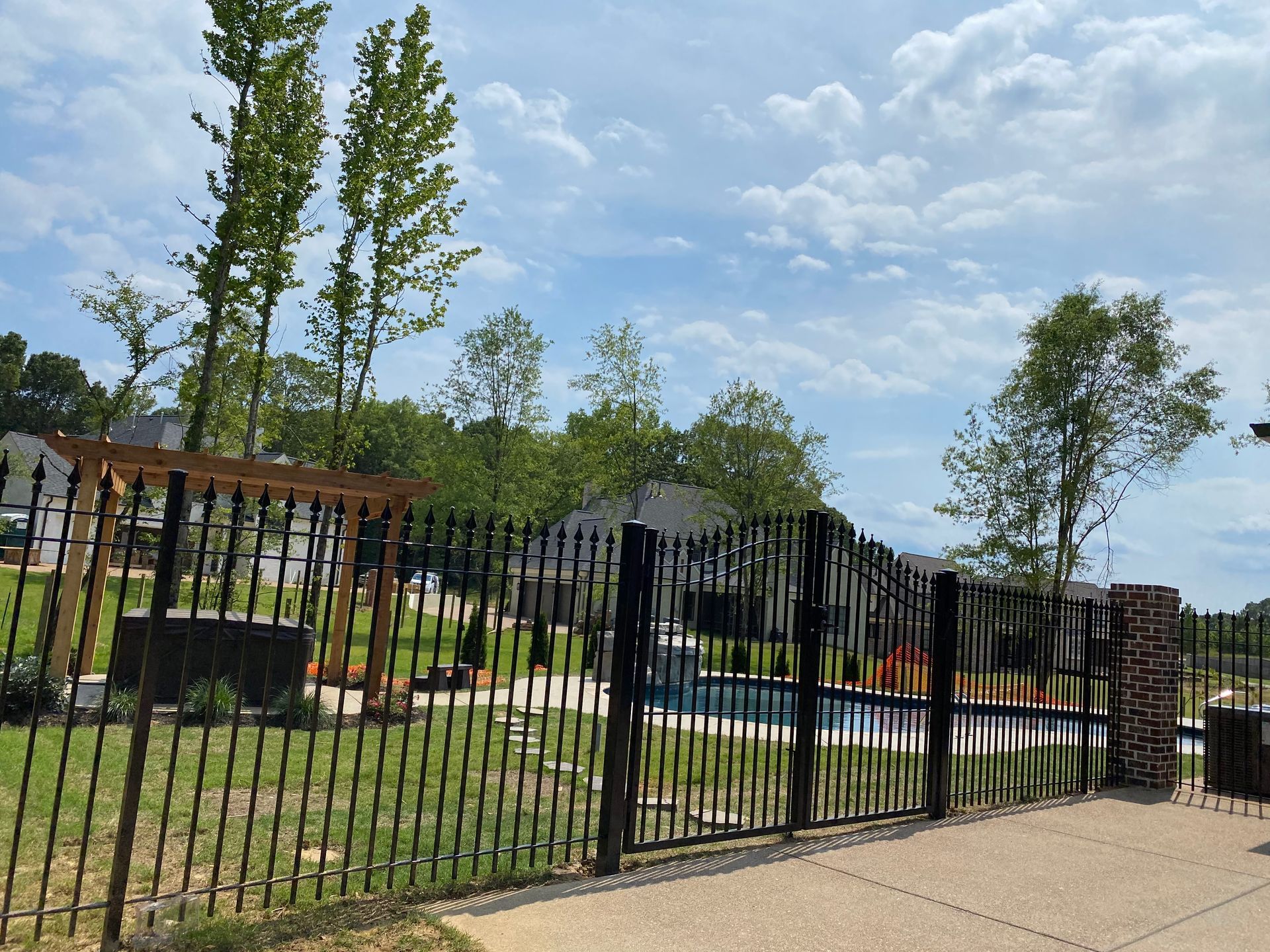 Iron fence with bell arch gate