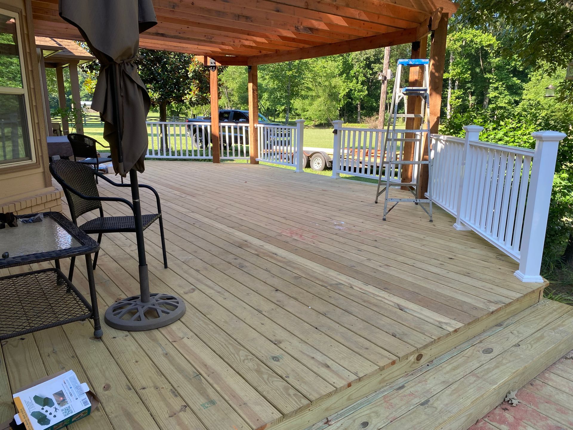 New treated deck with composite railing and redwood pergola