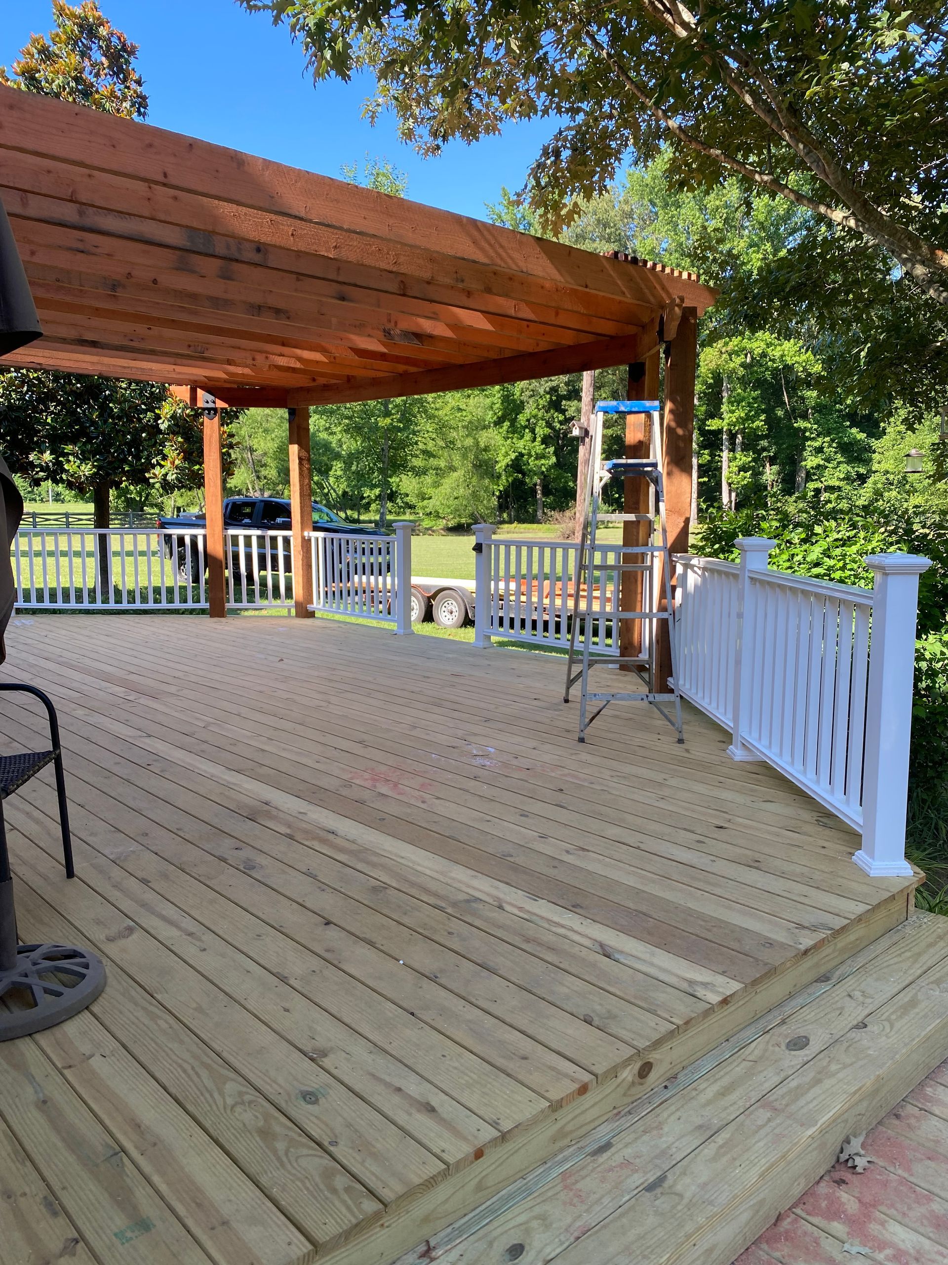New treated deck with composite railing and redwood pergola