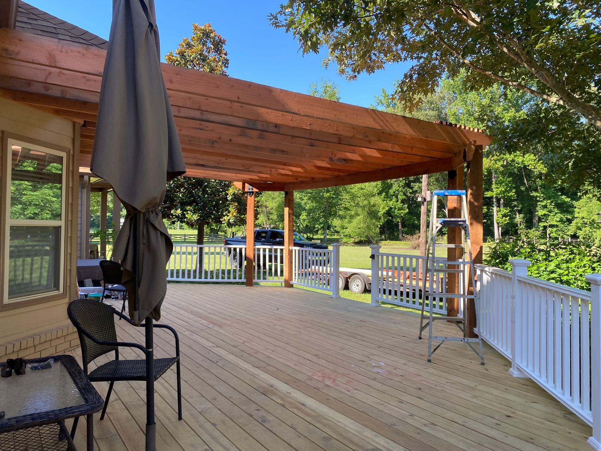 New treated deck with composite railing and redwood pergola