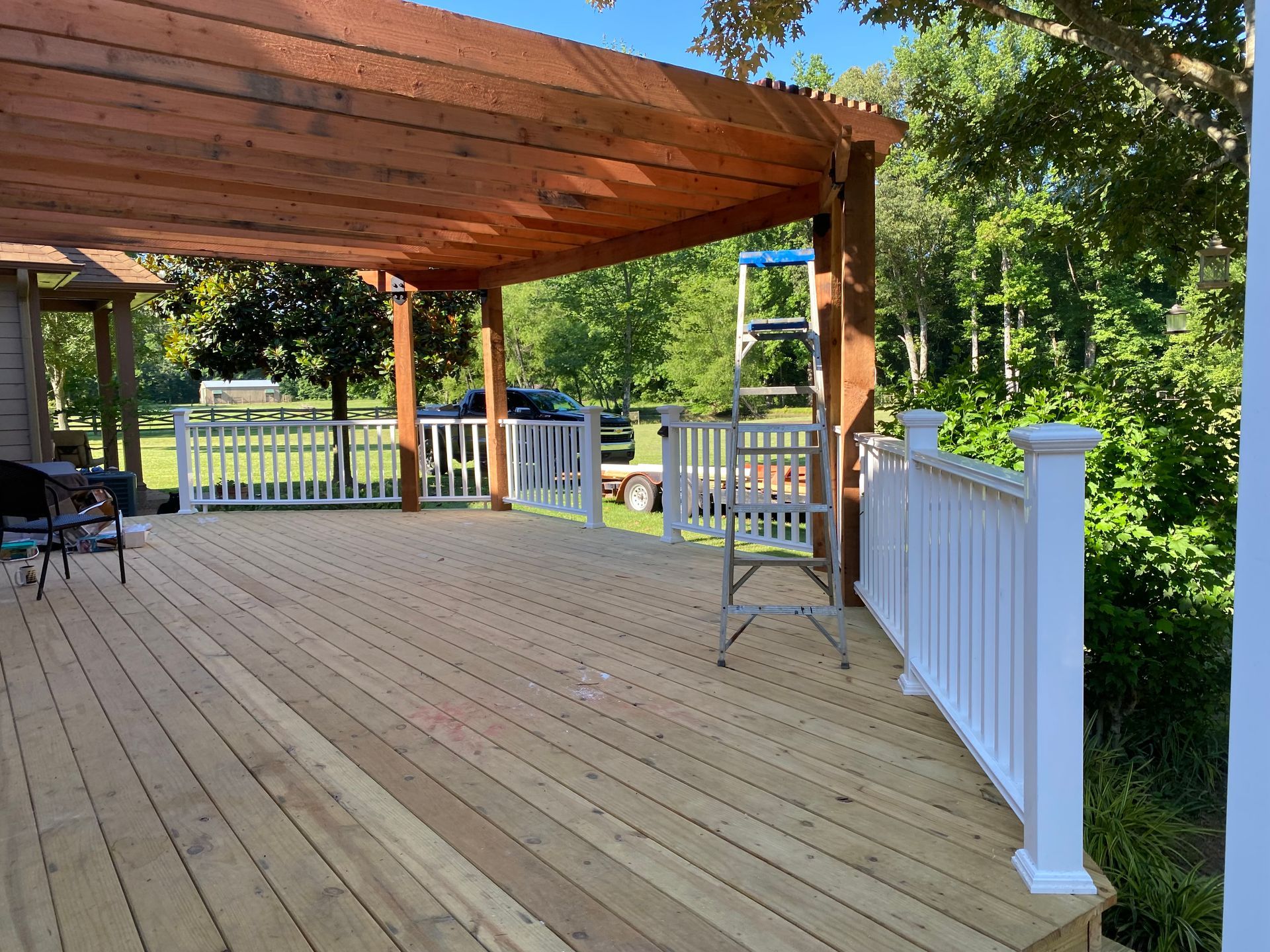 New treated deck with composite railing and redwood pergola