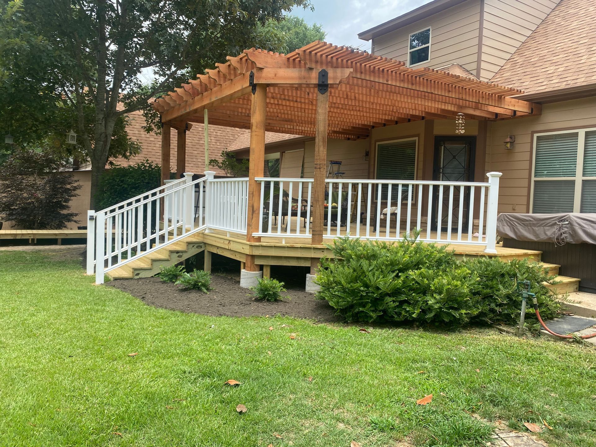 New treated deck with composite railing and redwood pergola