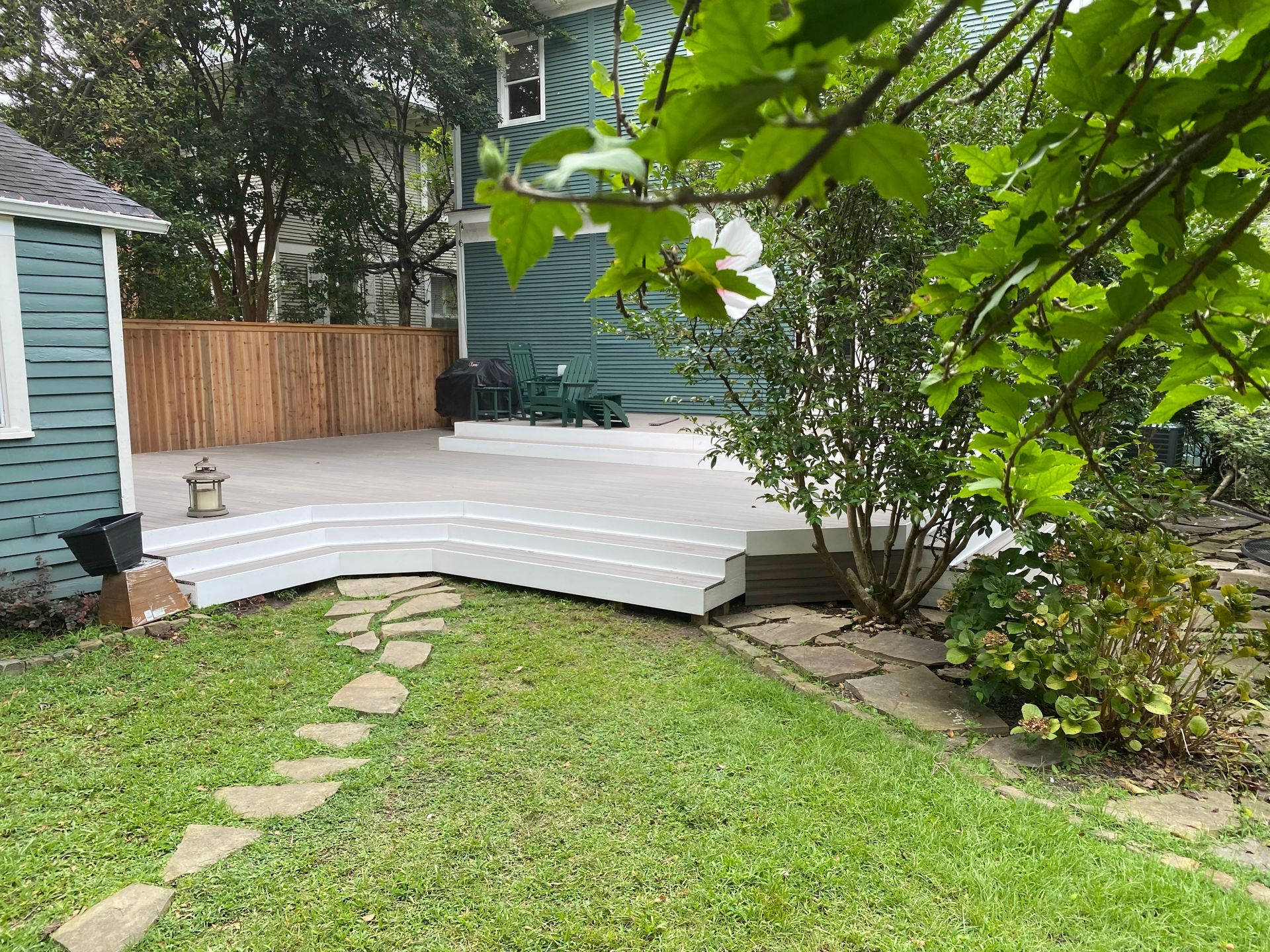 Composite deck with cedar fence behind