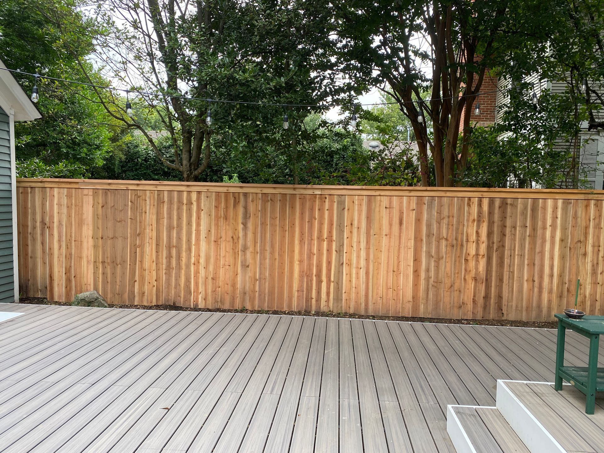 Composite deck with cedar fece behind