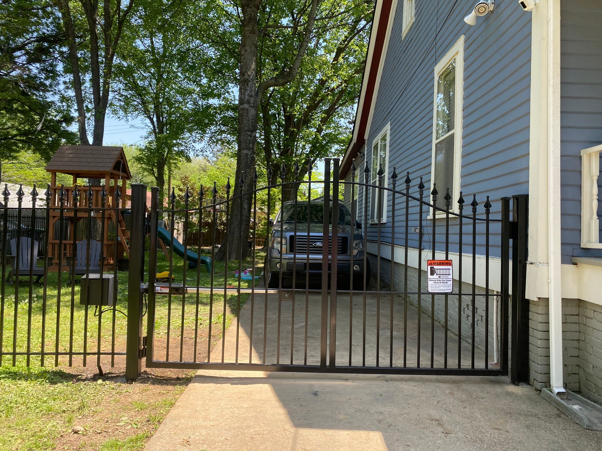 Iron fence with bell arch gate and automatic opener