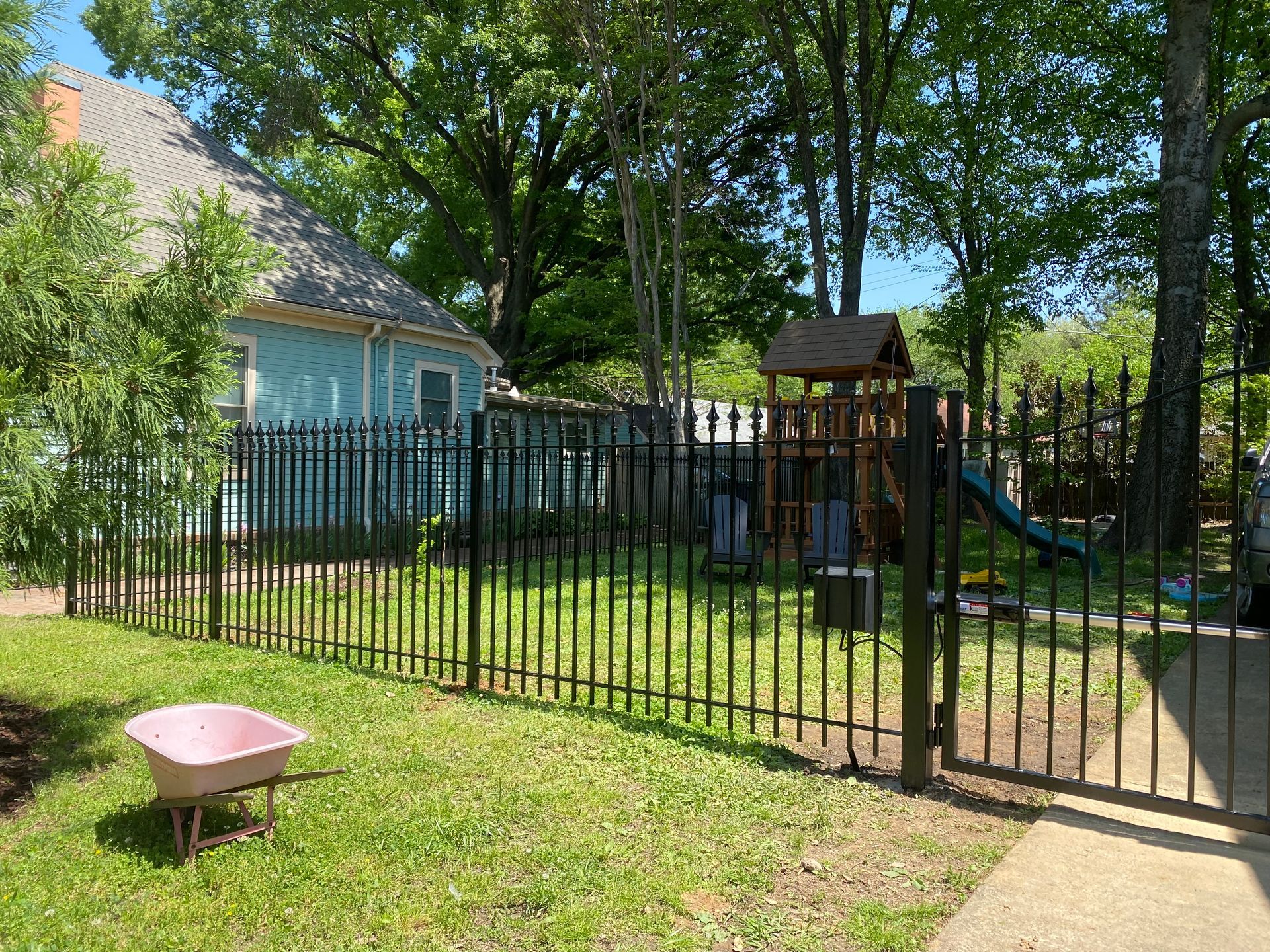 Iron fence with bell arch gate and automatic opener