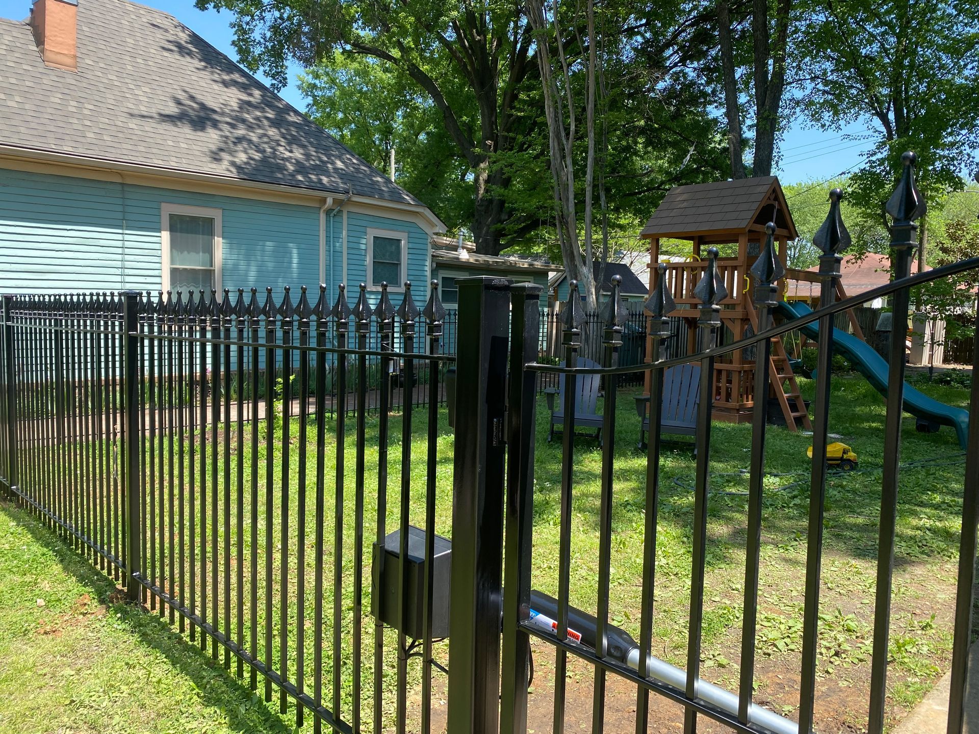 Iron fence with bell arch gate and automatic opener
