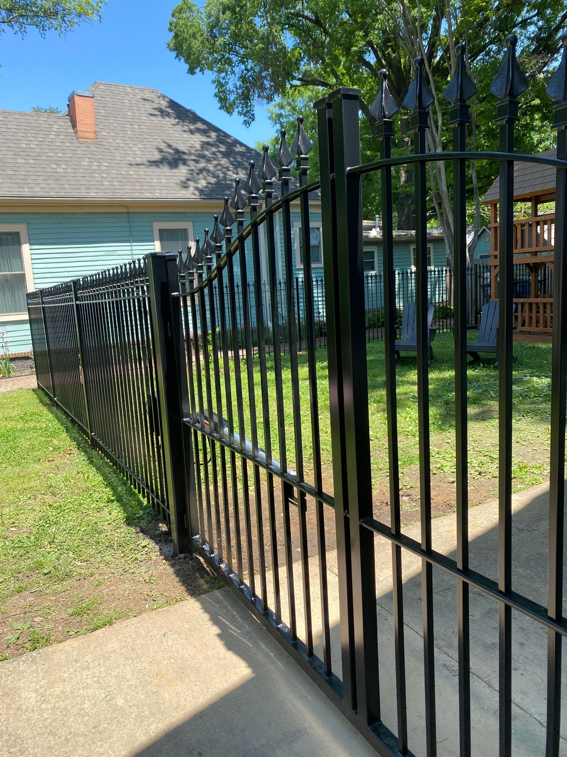 Iron fence with bell arch gate and automatic opener