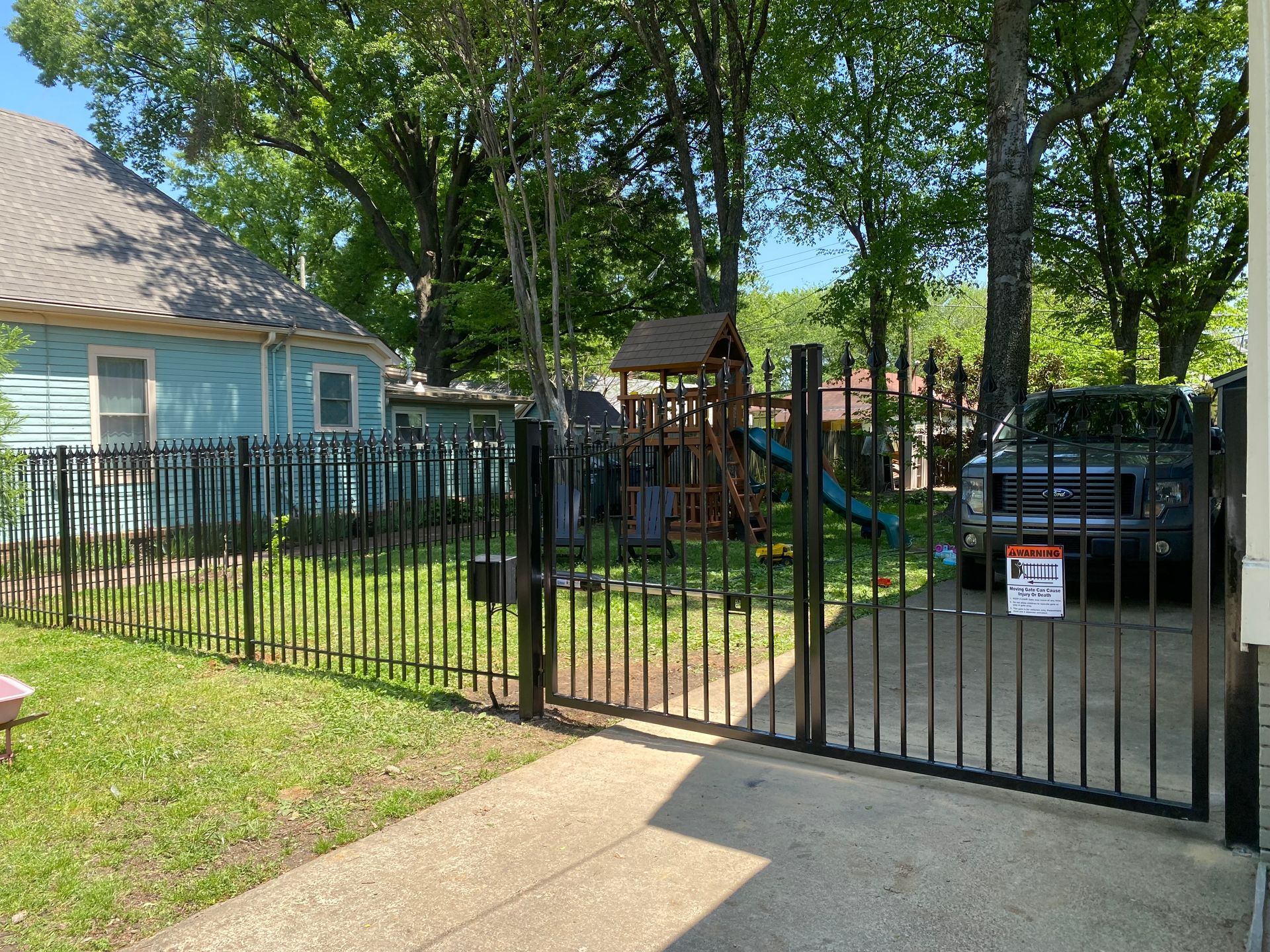 Iron fence with bell arch gate and automatic opener