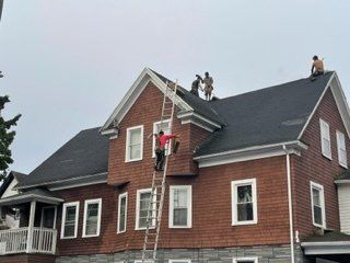 Workers at the Roof — Chicopee, MA — Nova Home Improvements