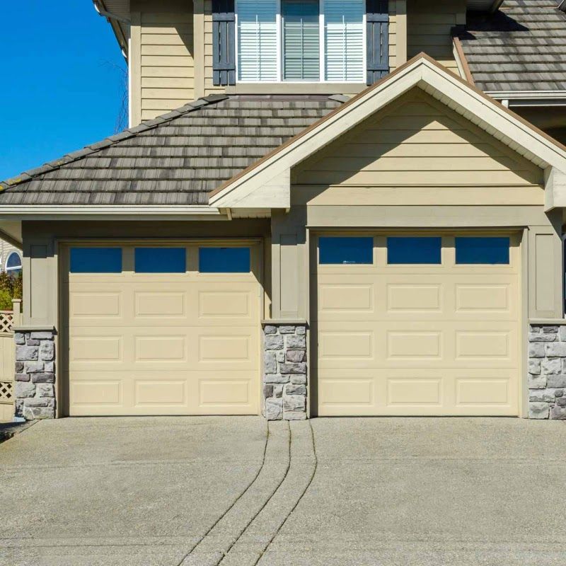 A house with two garage doors and a driveway