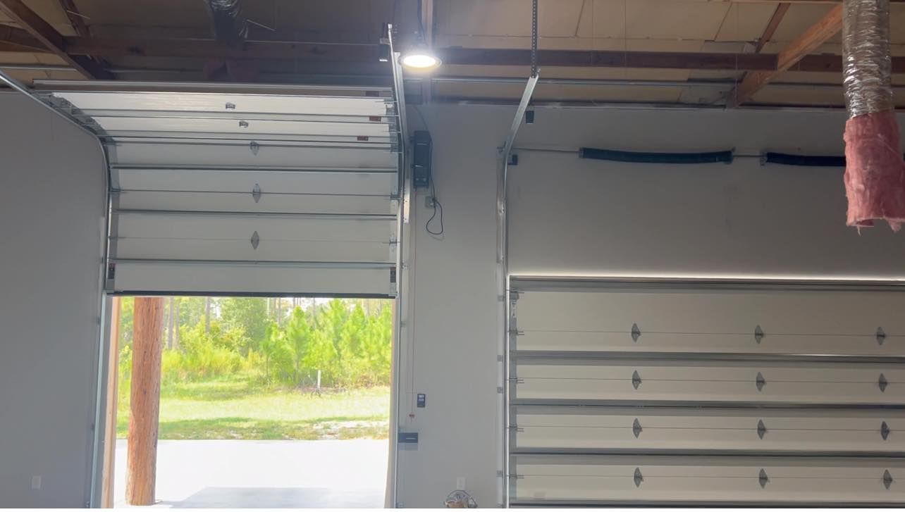 The garage door is open and the inside of the garage is empty.