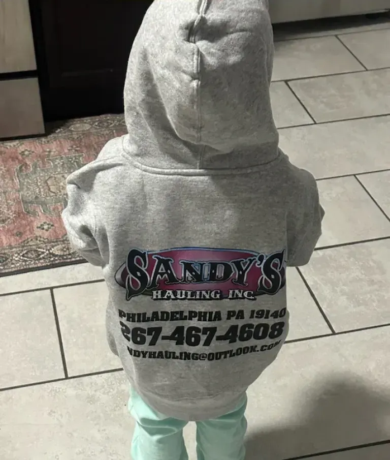 Child wearing a gray hoodie with 