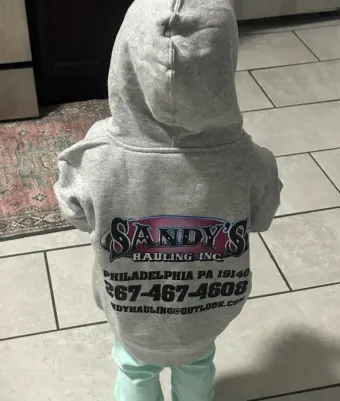 Child wearing a gray hoodie with