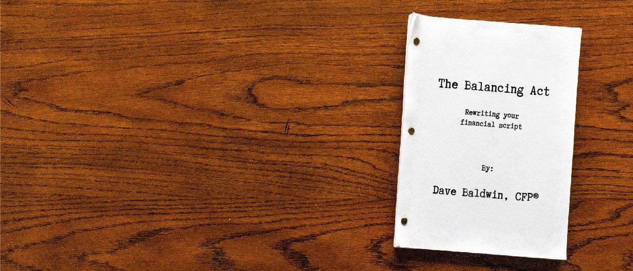 A small book is sitting on a wooden table.