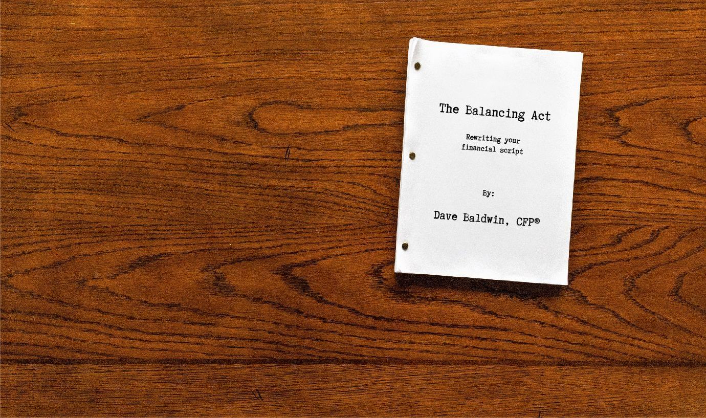 A small book is sitting on a wooden table.