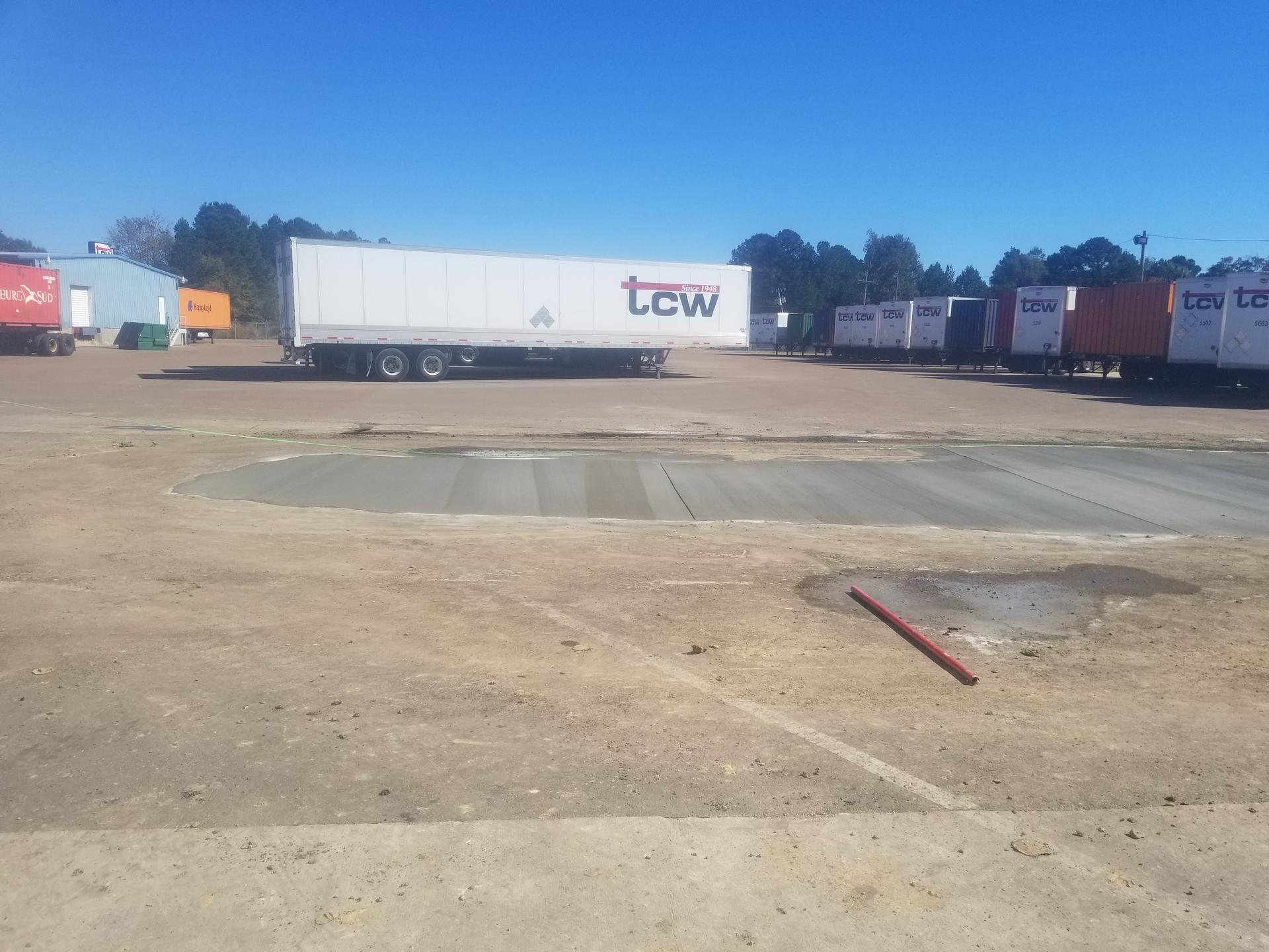 A tcw truck is parked in a parking lot