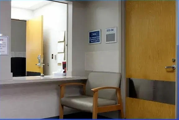 A waiting room with a chair and a counter