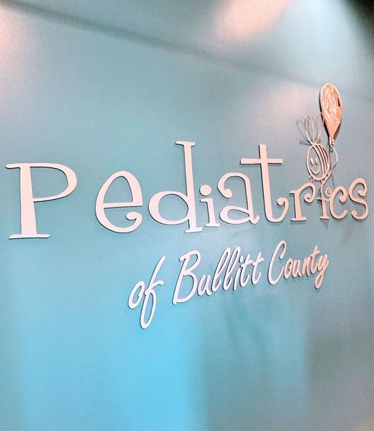 The words "Pediatrics of Bullitt County" on a blue wall.